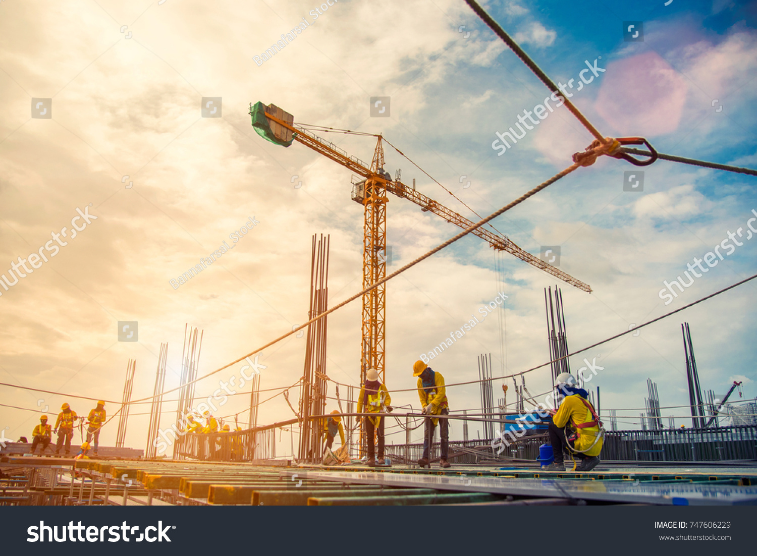 construction site and sunset , structural steel beam build large residential buildings at construction site . #747606229