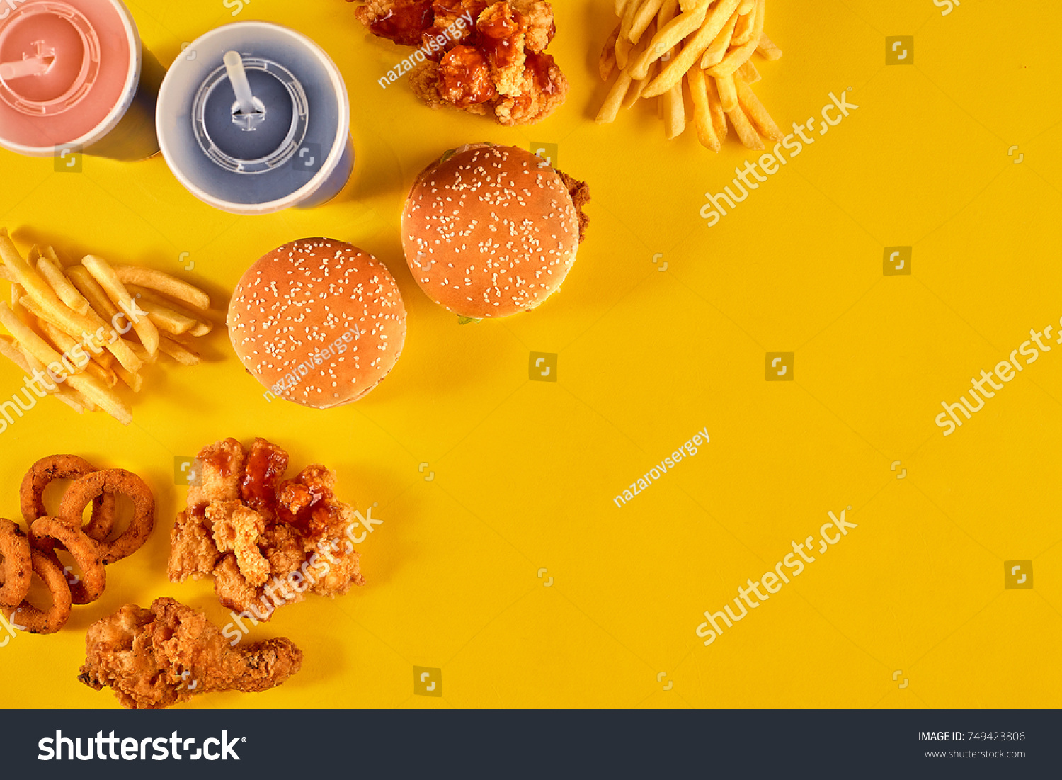 Fast food dish on yellow background. Fast food set fried chicken, meat burger and french fries. Take away fast food. #749423806