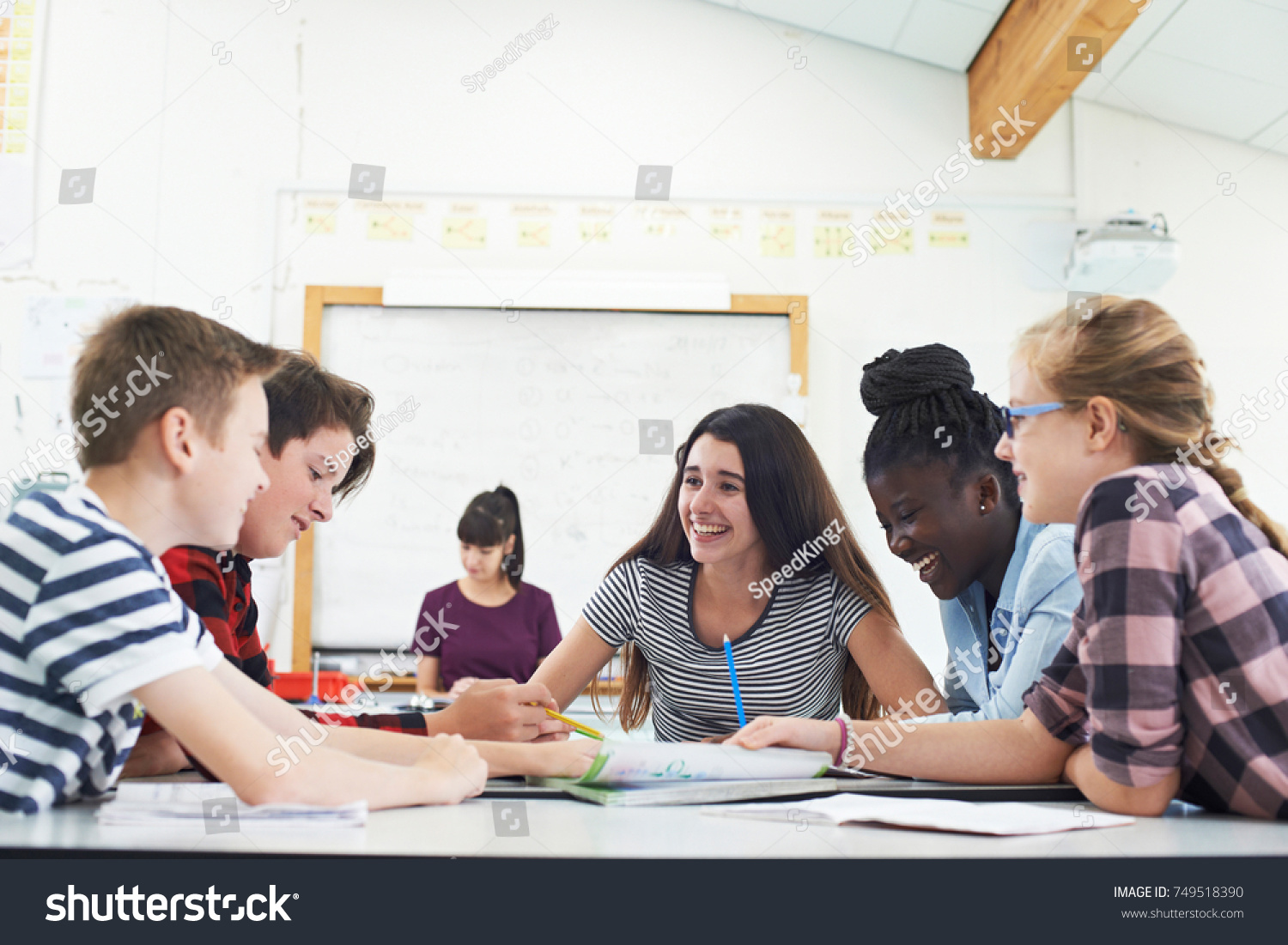Group Of Teenage Students Collaborating On Project In Classroom #749518390