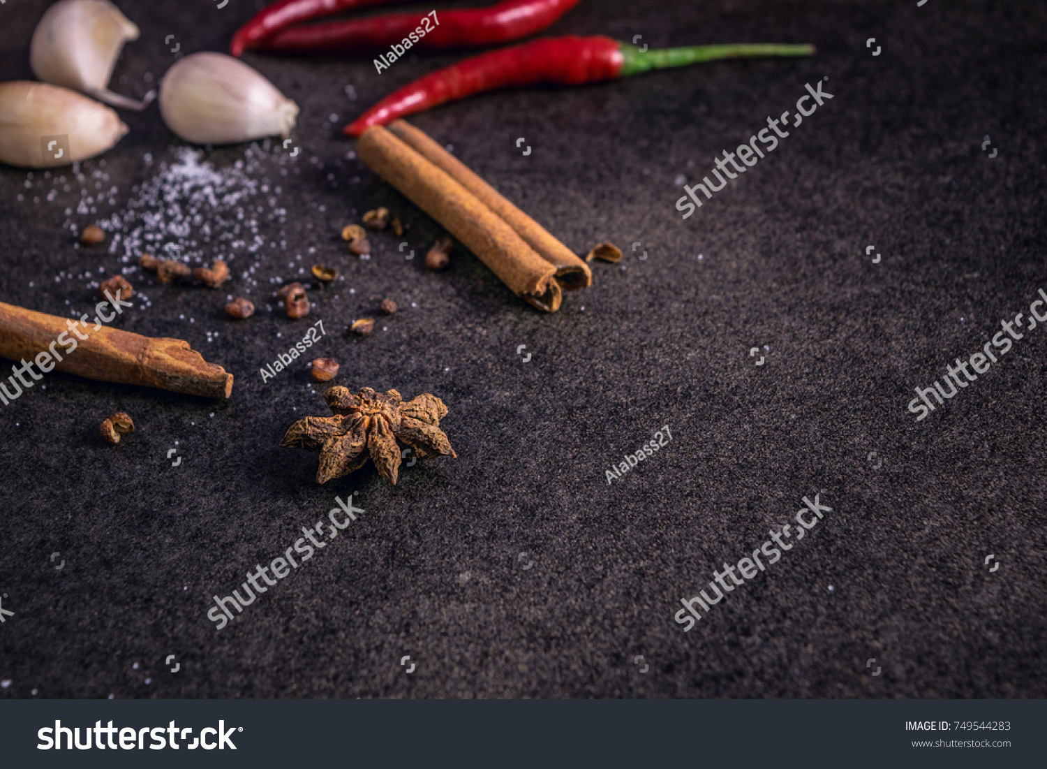 Herbs and spices over black stone background, mystic photography,  selective focus and dark background #749544283