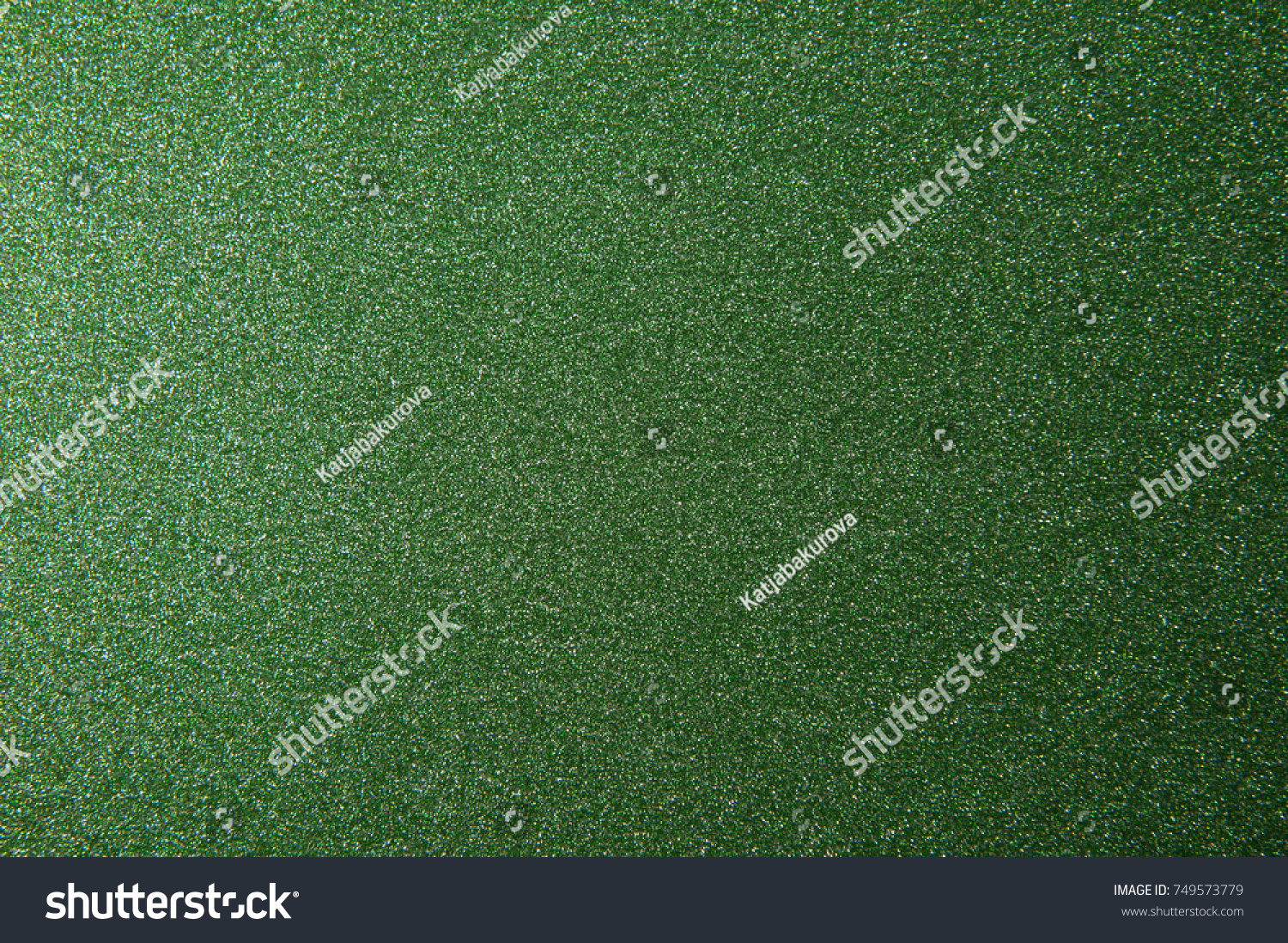 texture of green glitter paper background for design Christmas or New Year's cards #749573779