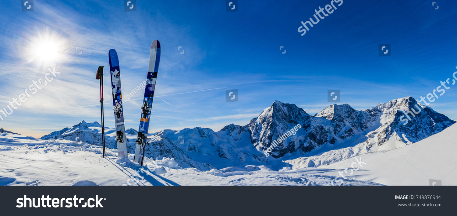 Ski in winter season, mountains and ski touring backcountry equipments on the top of snowy mountains in sunny day. South Tirol, Solda in Italy. #749876944