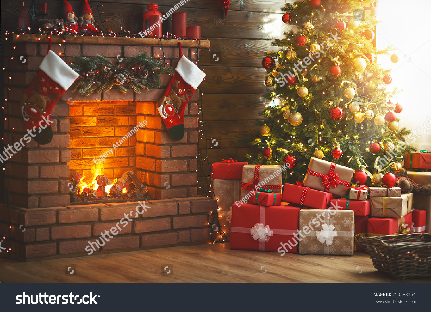 interior christmas. magic glowing tree, fireplace and gifts   #750588154