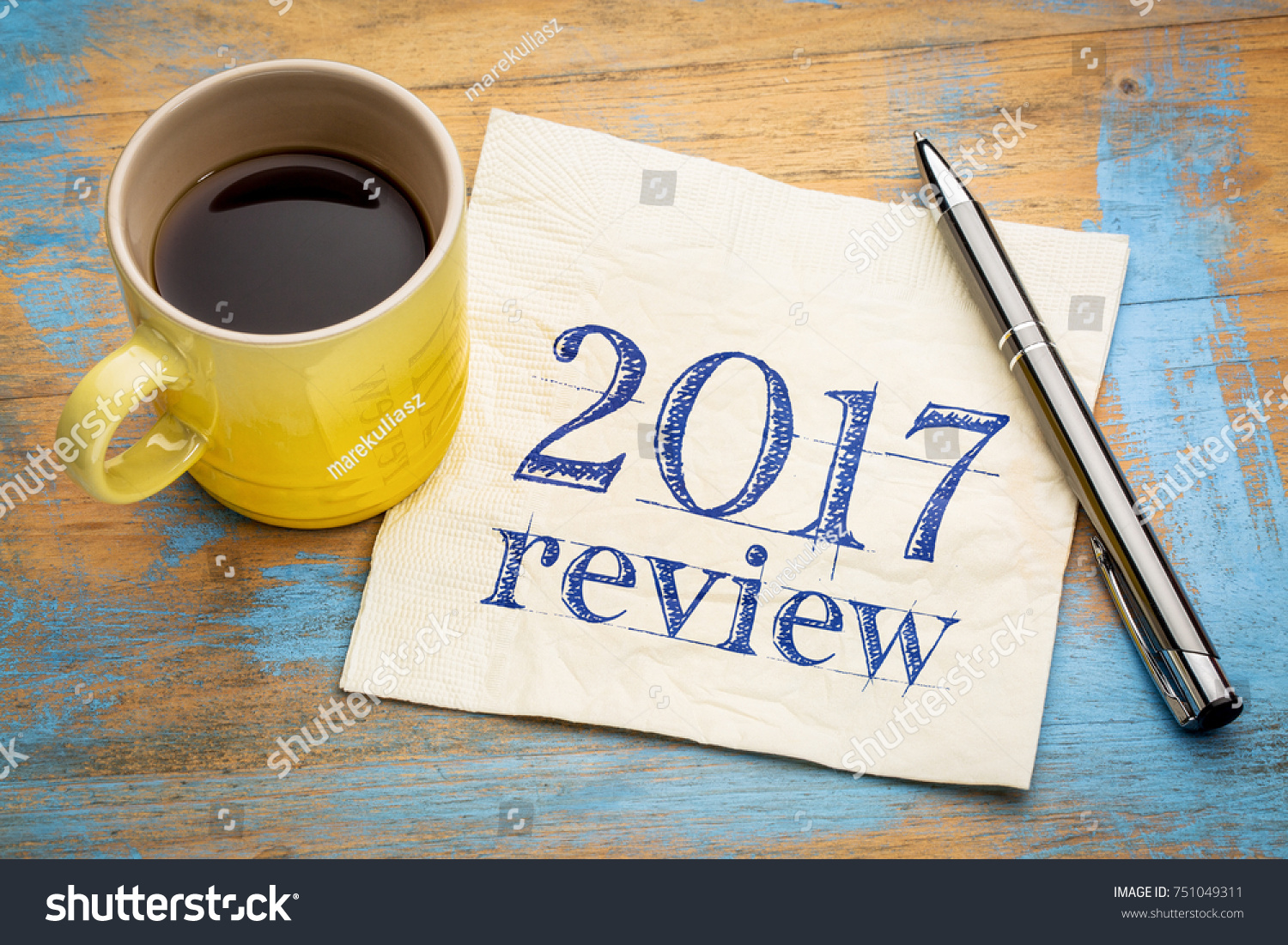 2017 review text on a napkin with coffee against grunge wood desk #751049311