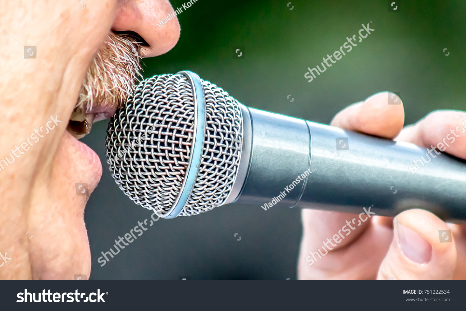 A man sings into a microphone #751222534