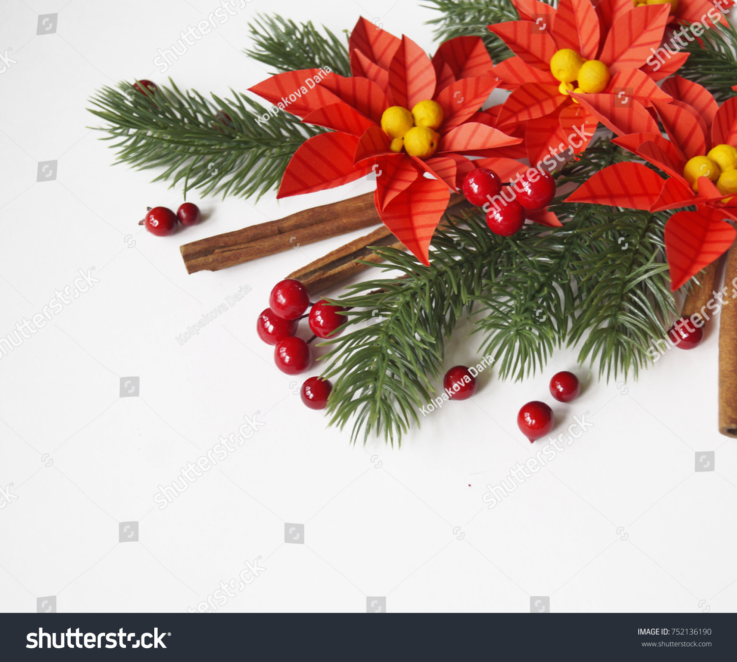 Paper flower poinsettia and spruce branches. Christmas composition. White background. Colors are green, red, yellow. #752136190