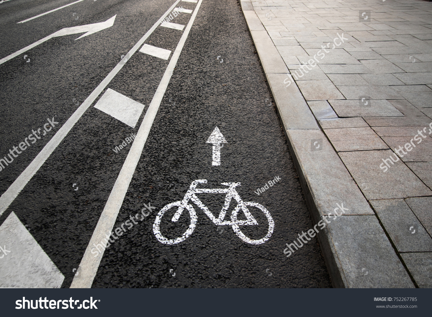 Separate bicycle lane for riding bicycles. White painted bike on asphalt. Ride ecological green urban transport #752267785