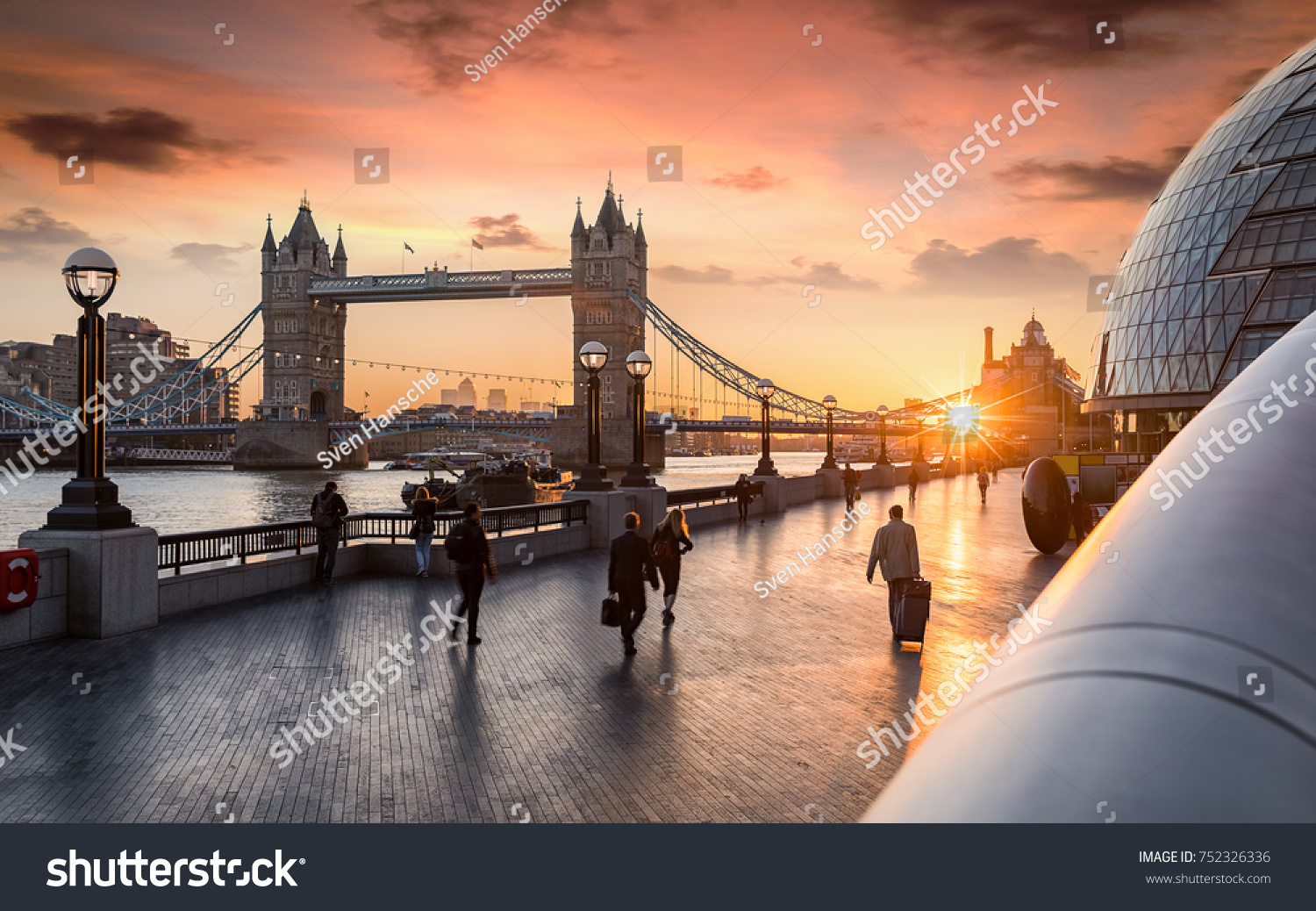 The Tower Bridge in London during sunrise and people rushing to their work #752326336