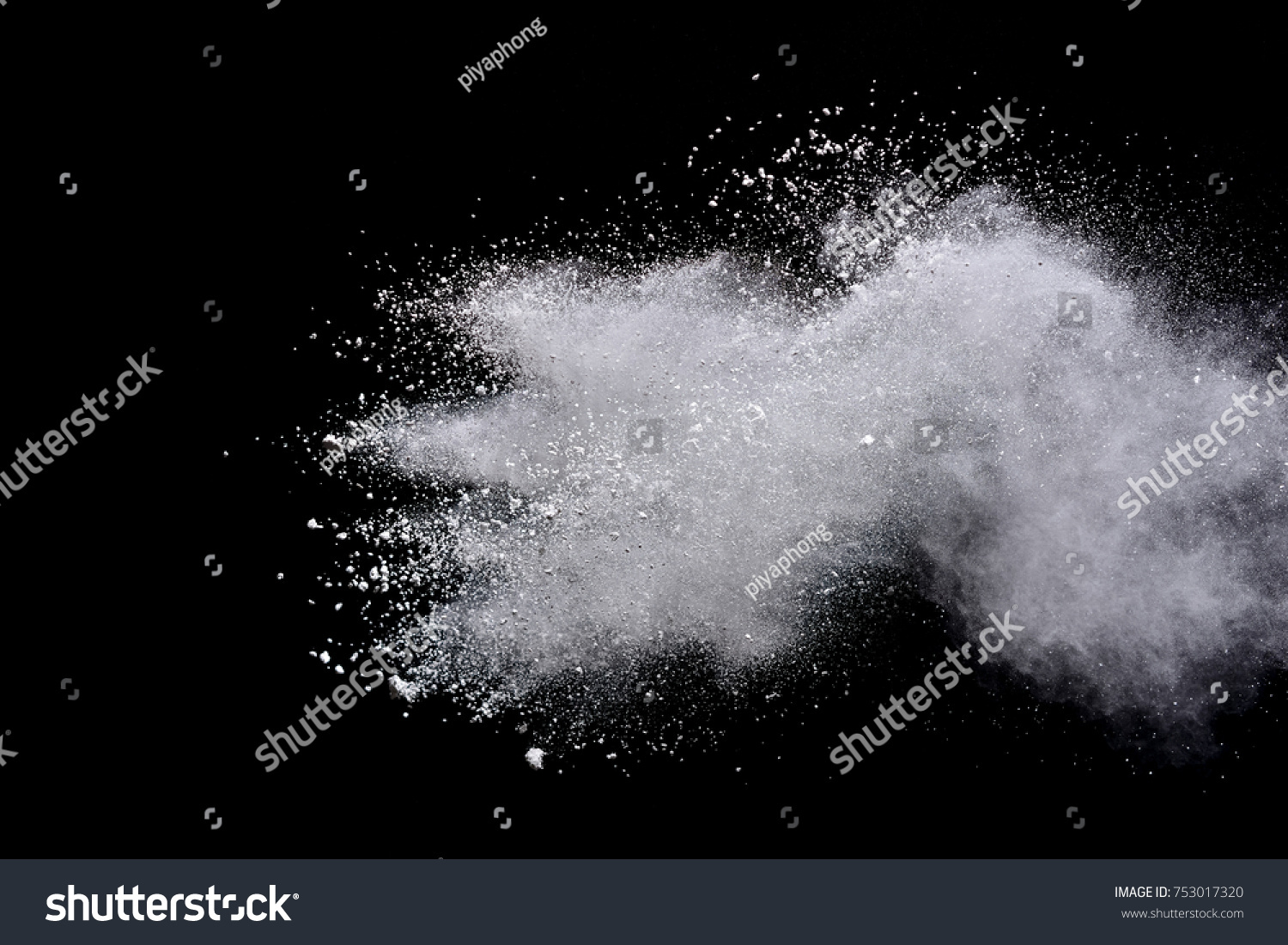 Freeze motion of white powder explosions isolated on black background #753017320
