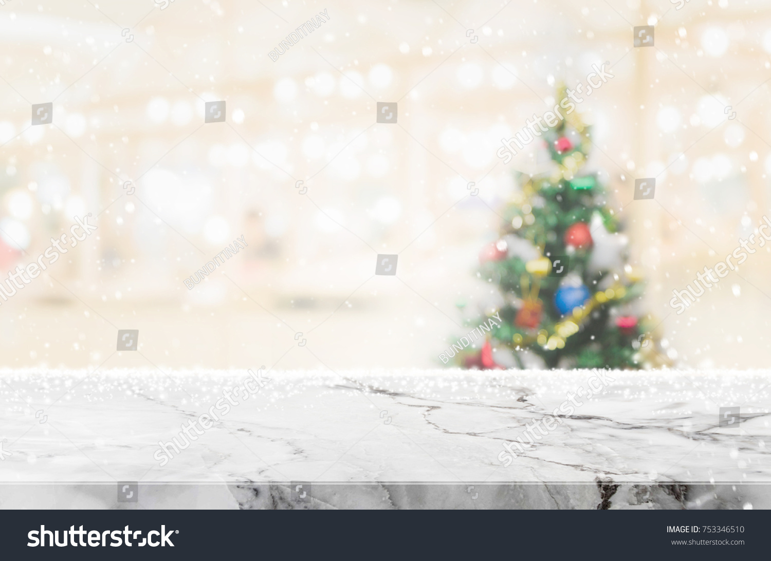 White marble stone table top on blur with bokeh christmas tree background with snowfall - can be used for display or montage your products. #753346510