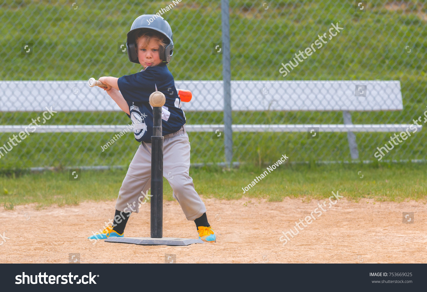 Young Child Playing Baseball #753669025
