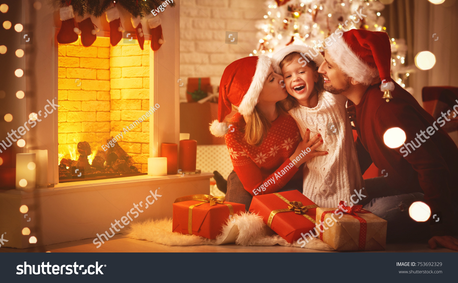 Merry Christmas! happy family mother father and child with magic gift near tree #753692329