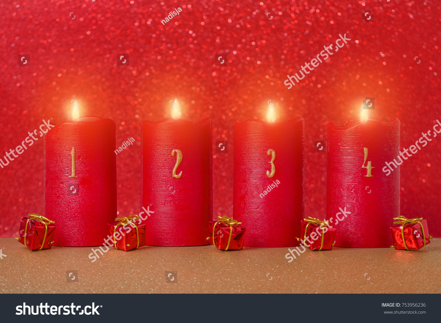 traditional advent candles with numbers and gifts on red background, selective focus #753956236