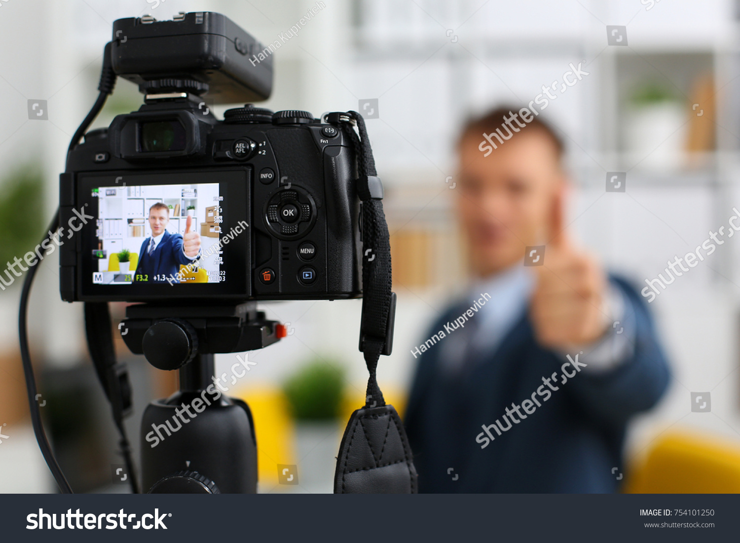 Male in suit and tie show confirm sign arm making promo videoblog or photo session in office camcorder to tripod closeup. Vlogger promotion selfie solution or finance advisor management information #754101250