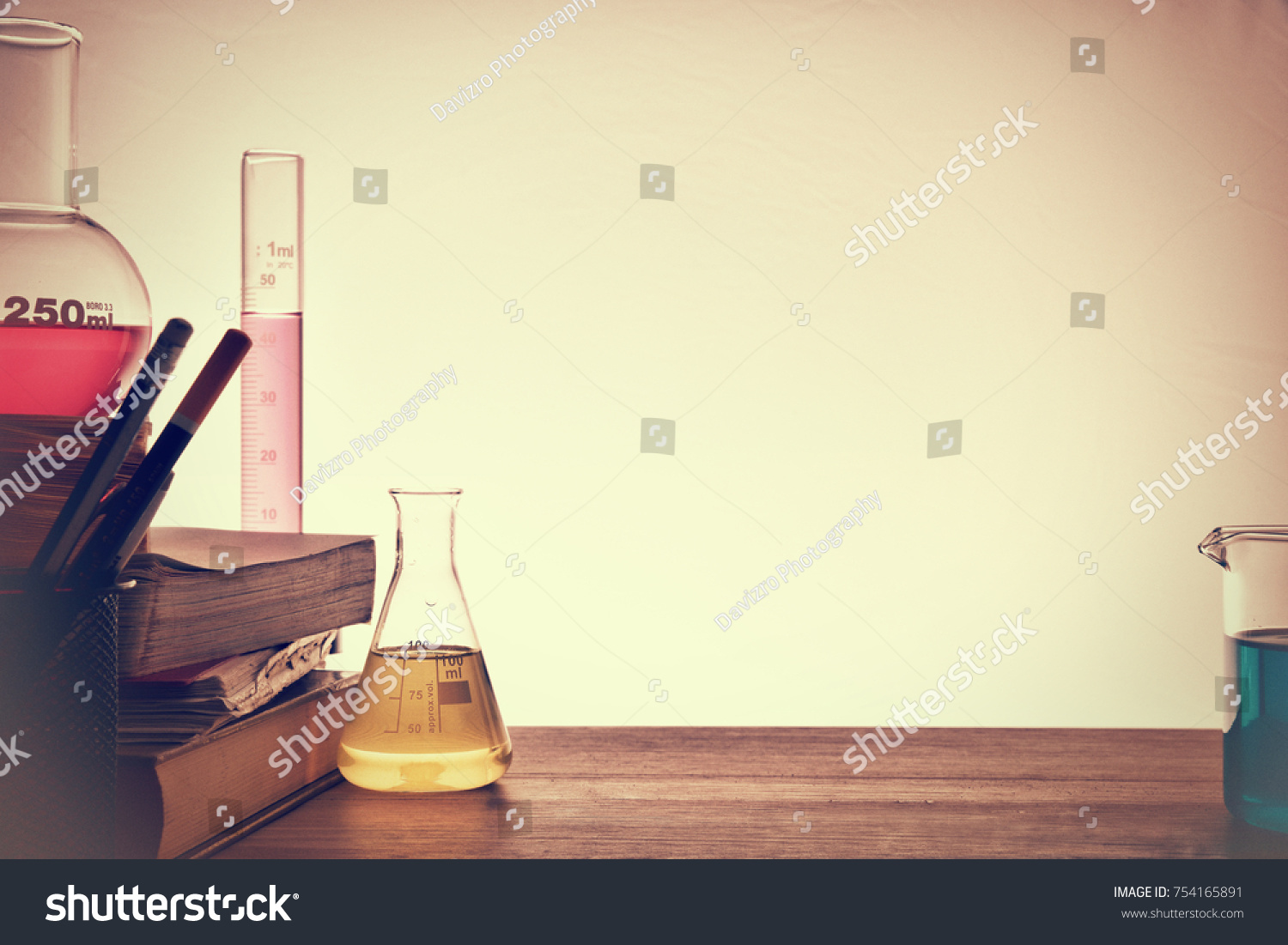 Classroom desk of chemistry teaching with books and instruments. Chemical sciences education concept. Horizontal composition. Front view #754165891