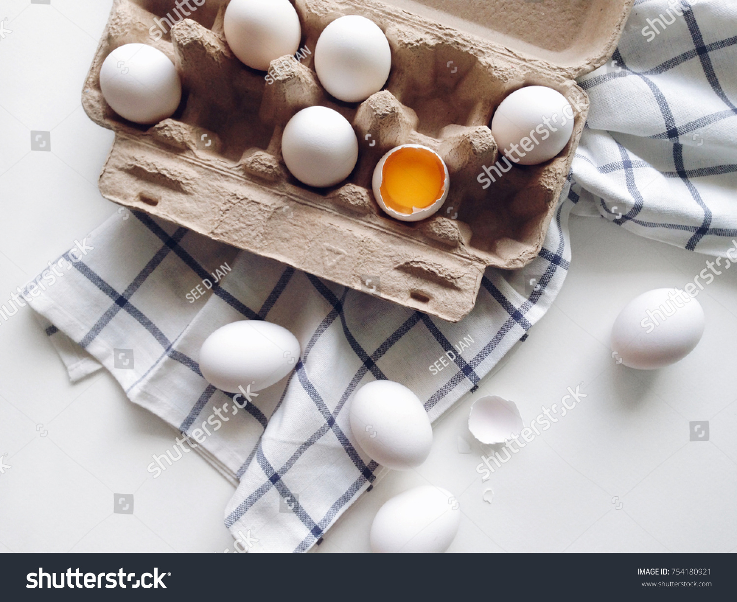 Organic white eggs in package on a kitchen table, egg yolk top view #754180921