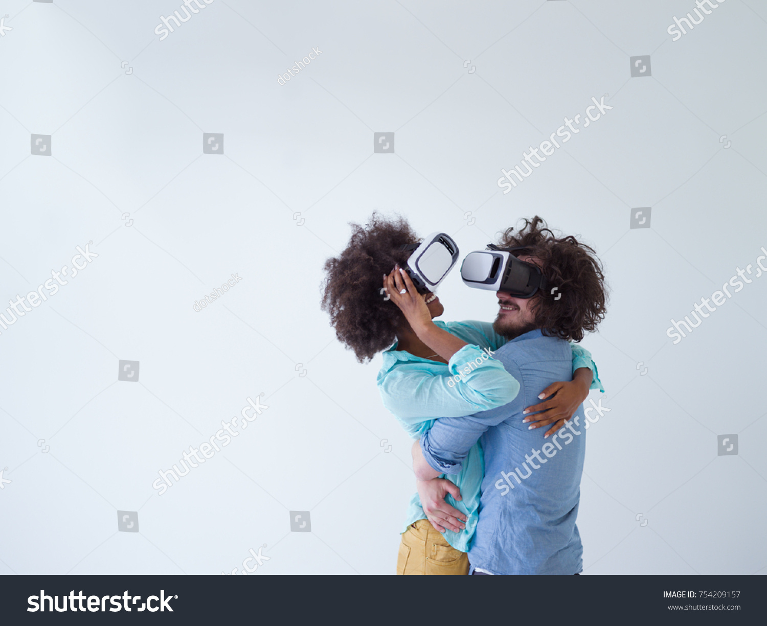 Happy multiethnic couple getting experience using VR headset glasses of virtual reality, isolated on white background #754209157