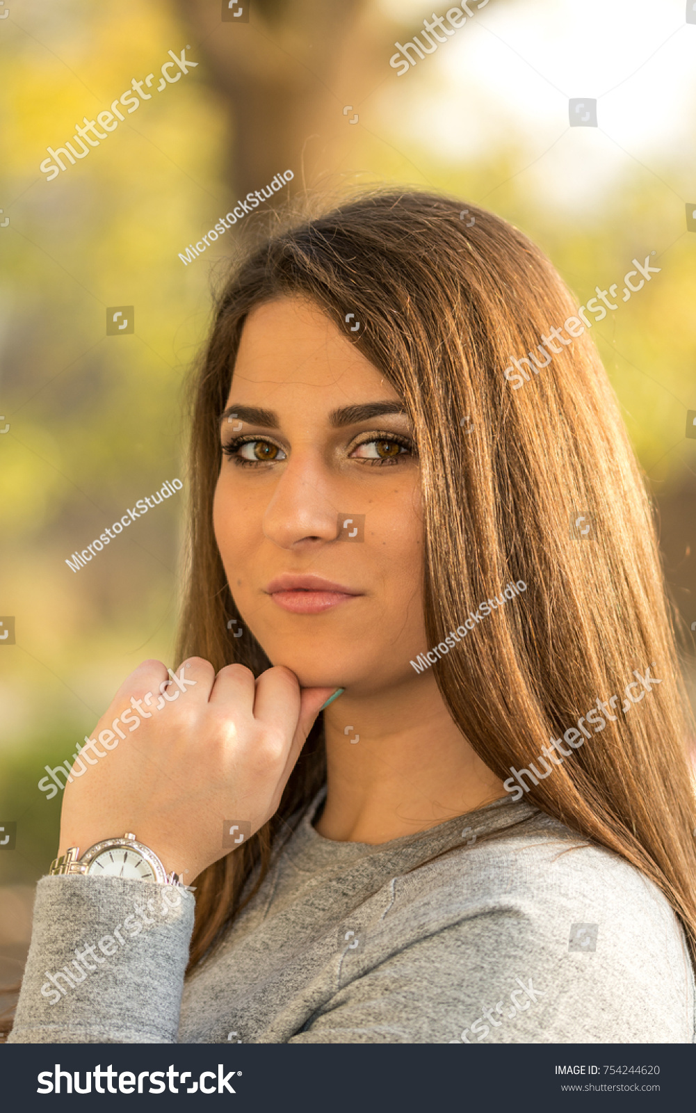 Beautiful young smiling girl headshot portrait with blurred background. #754244620