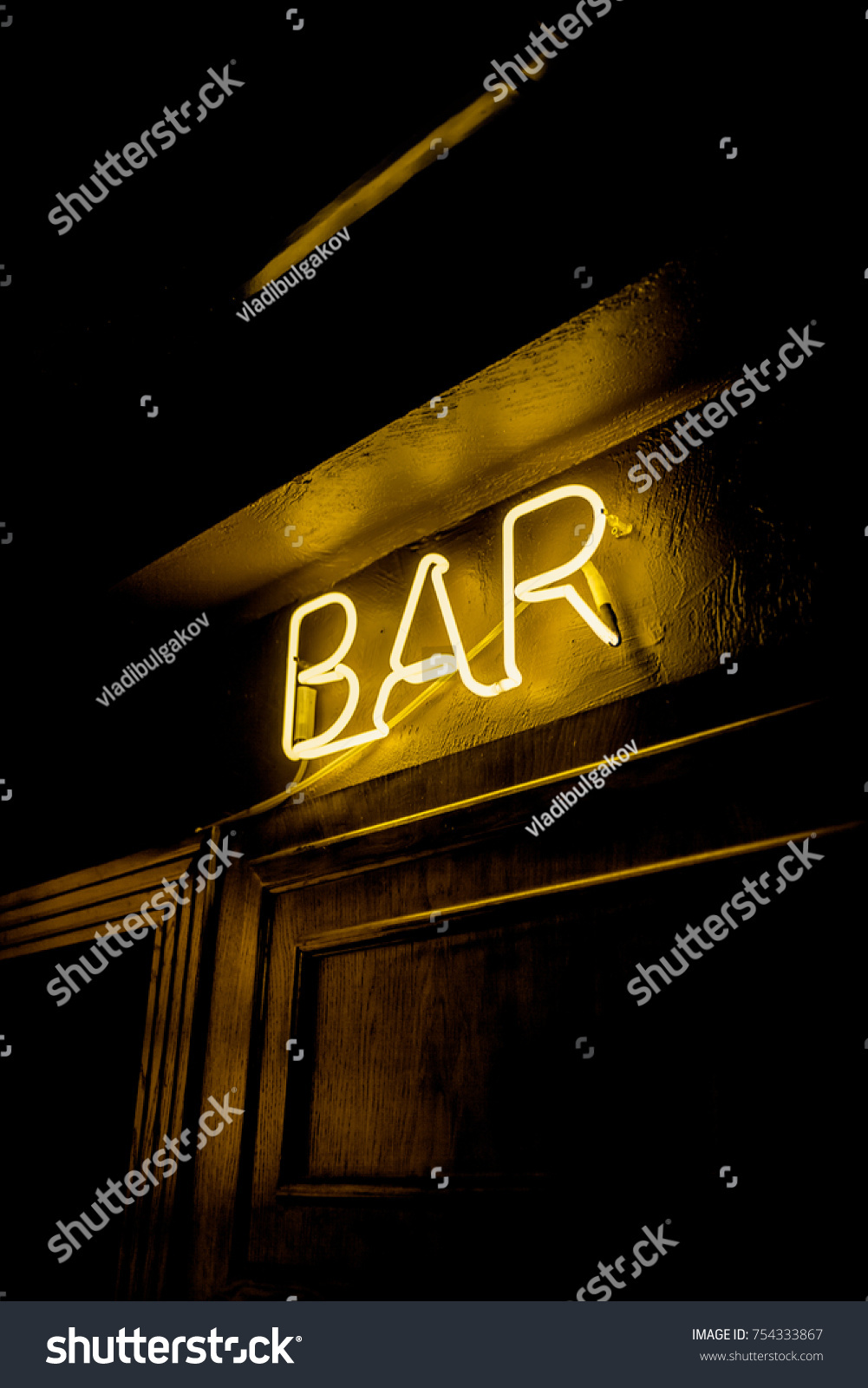 Neon inscription BAR on the wall. Neon inscription BAR in different colors. Multicolored neon inscription BAR on dark background #754333867