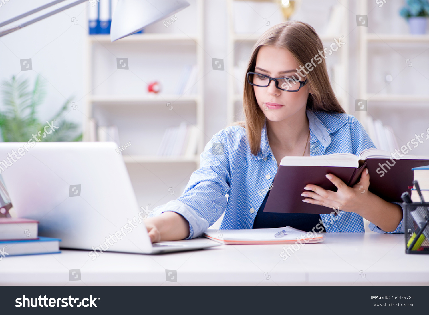 Young teenage female student preparing for exams at home #754479781