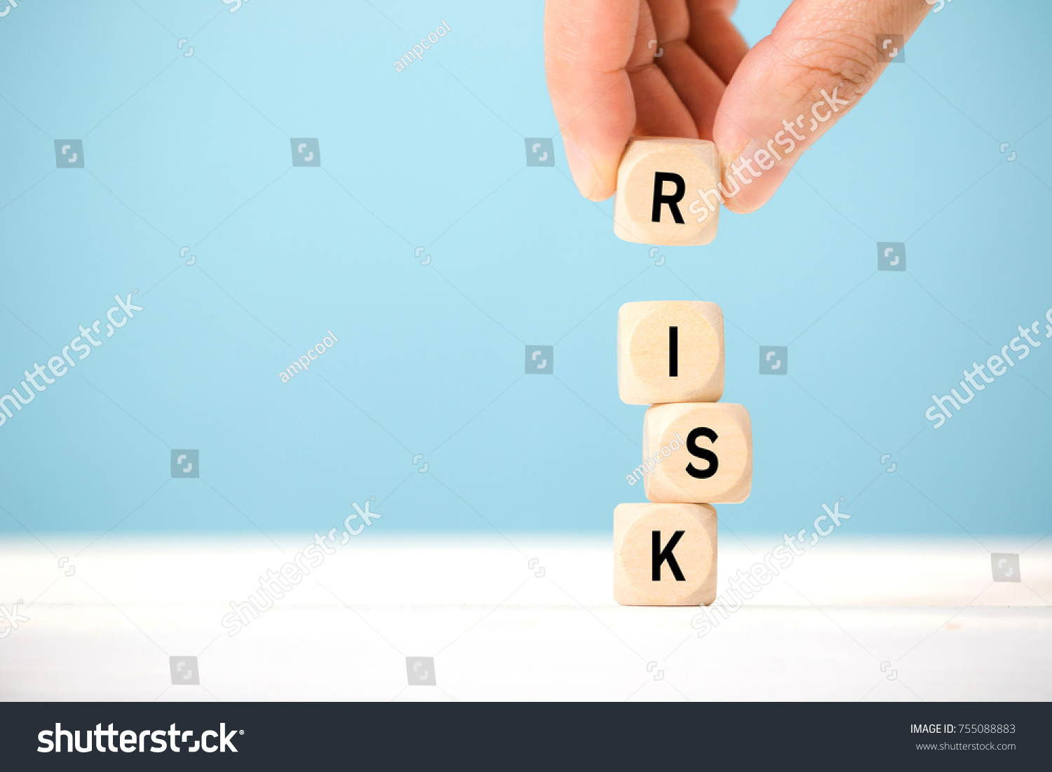 Hand hold wooden cubes with risk word. Risk management concept. #755088883