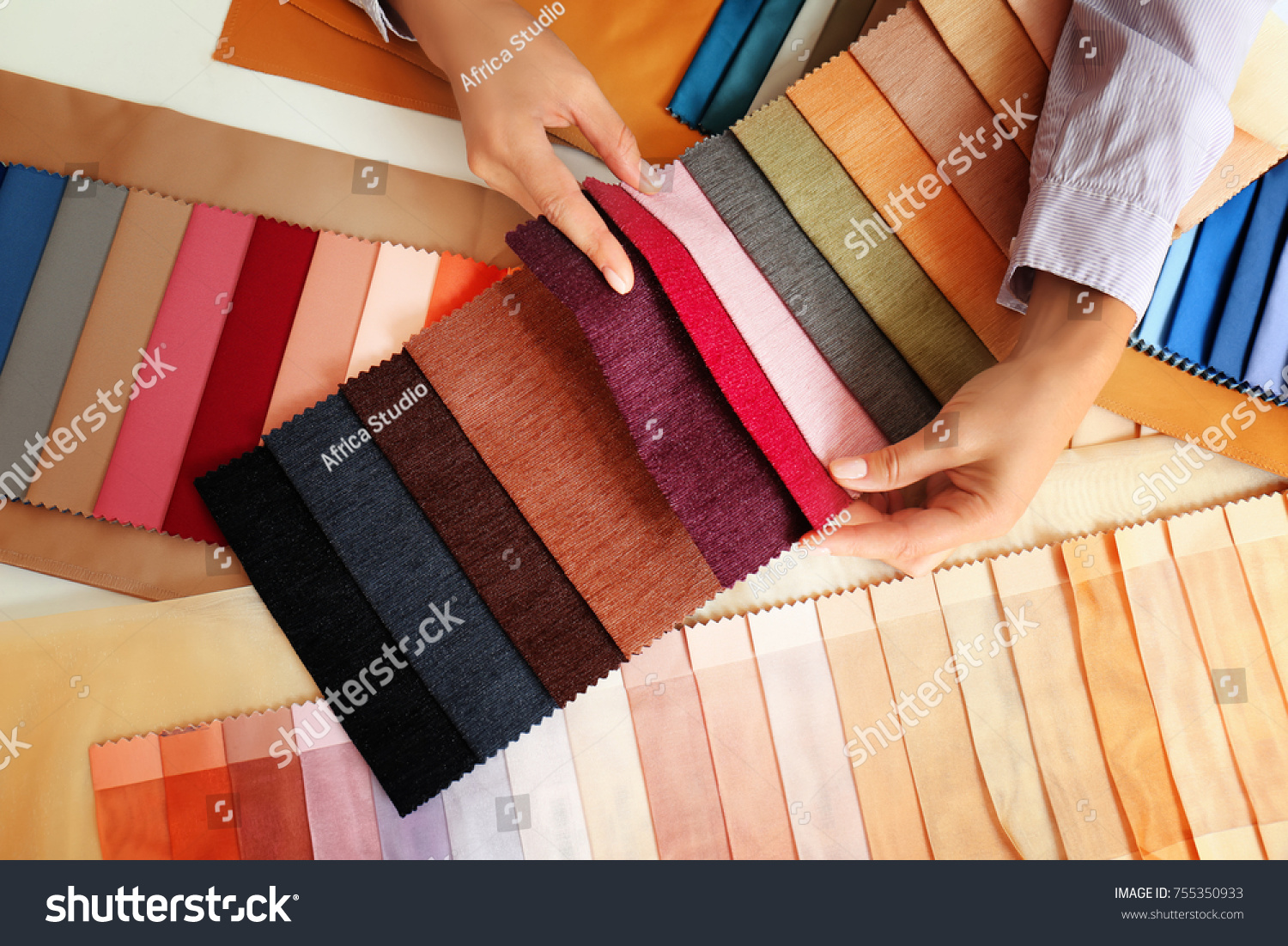 Young woman with fabric samples for curtains at table #755350933