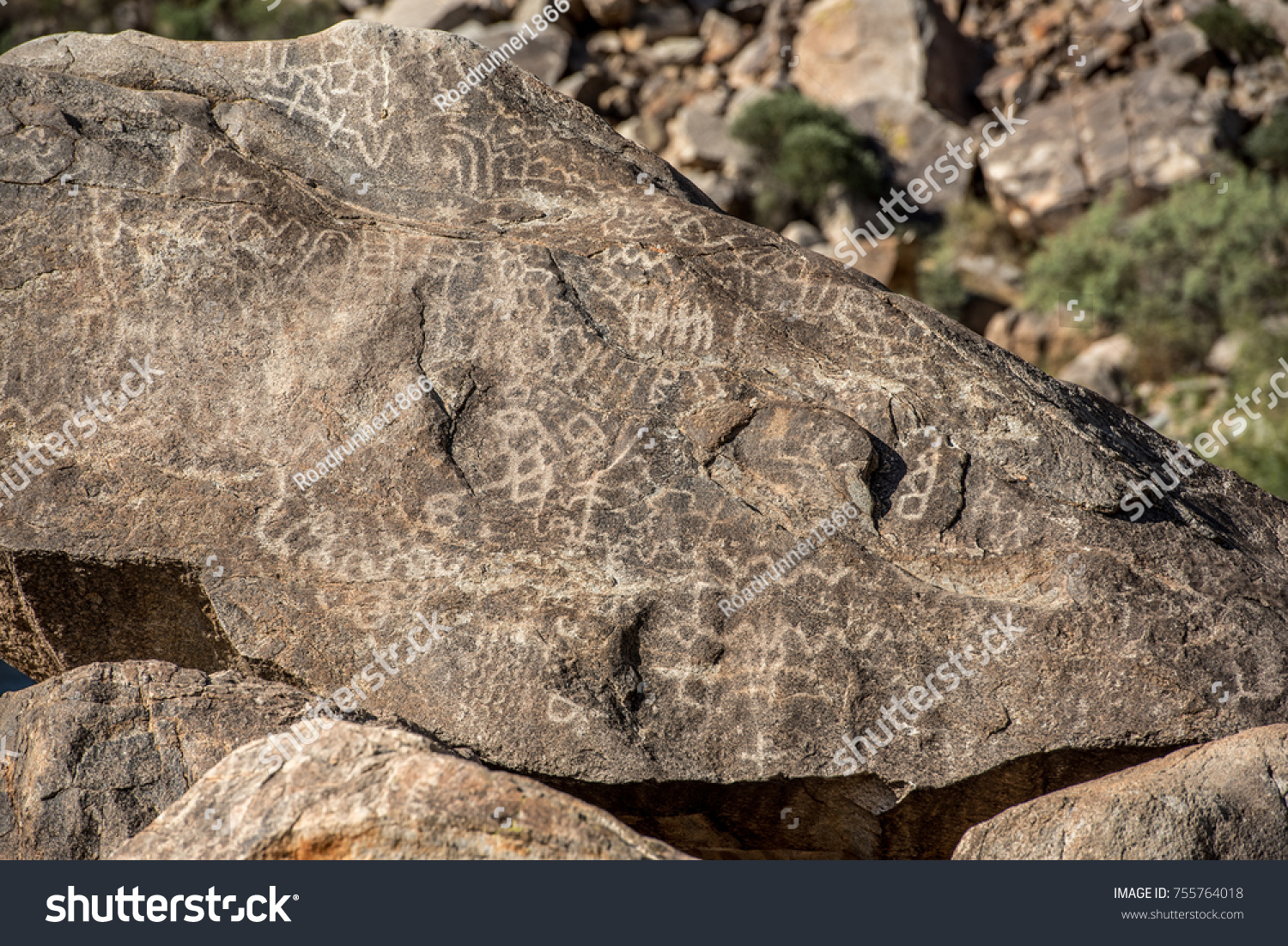 Closeup of petroglyphs etched in rocks in Arizona on a sunny day #755764018
