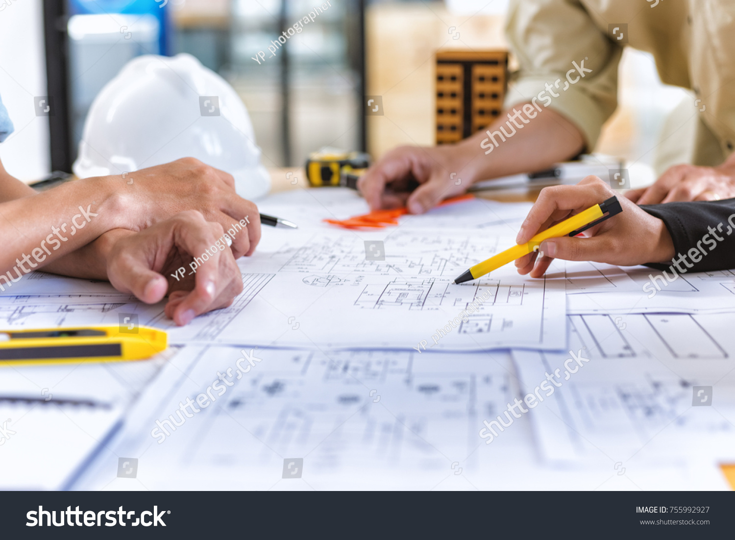 Image of team engineer checks construction blueprints on new project with engineering tools at desk in office. #755992927