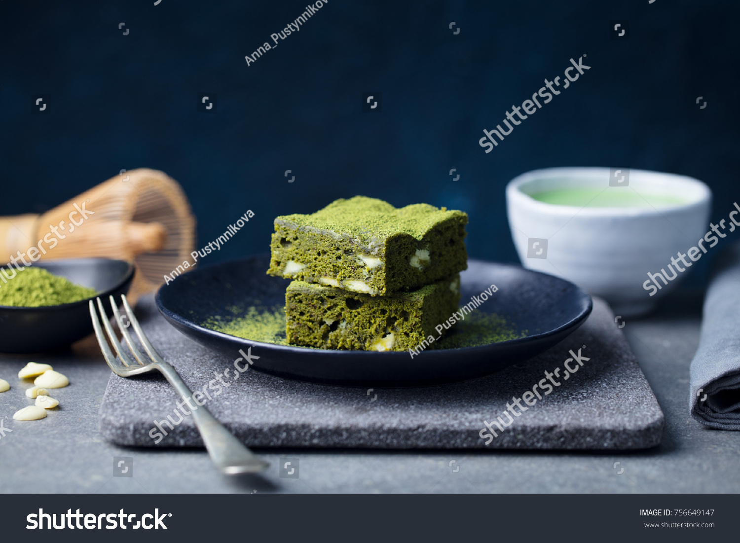 Matcha green tea cake, bars, brownie with white chocolate on a plate. Grey stone background. Copy space. #756649147
