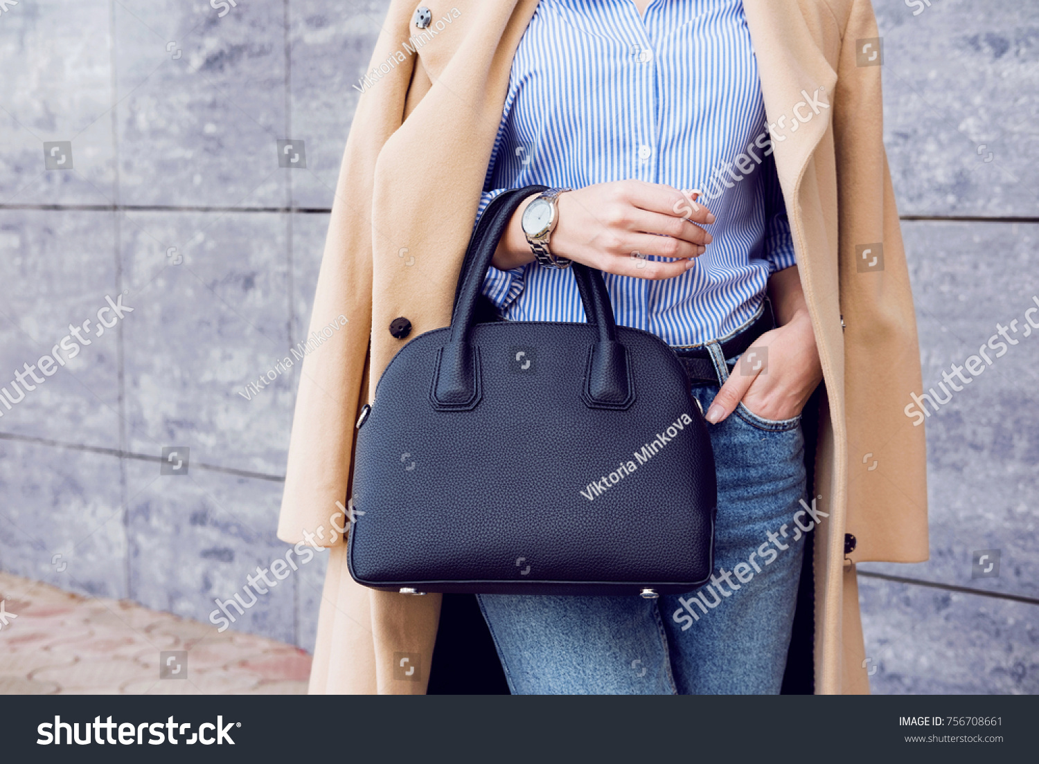Autumn trendy outfit woman in stylish beige coat and jeans with black big bag #756708661