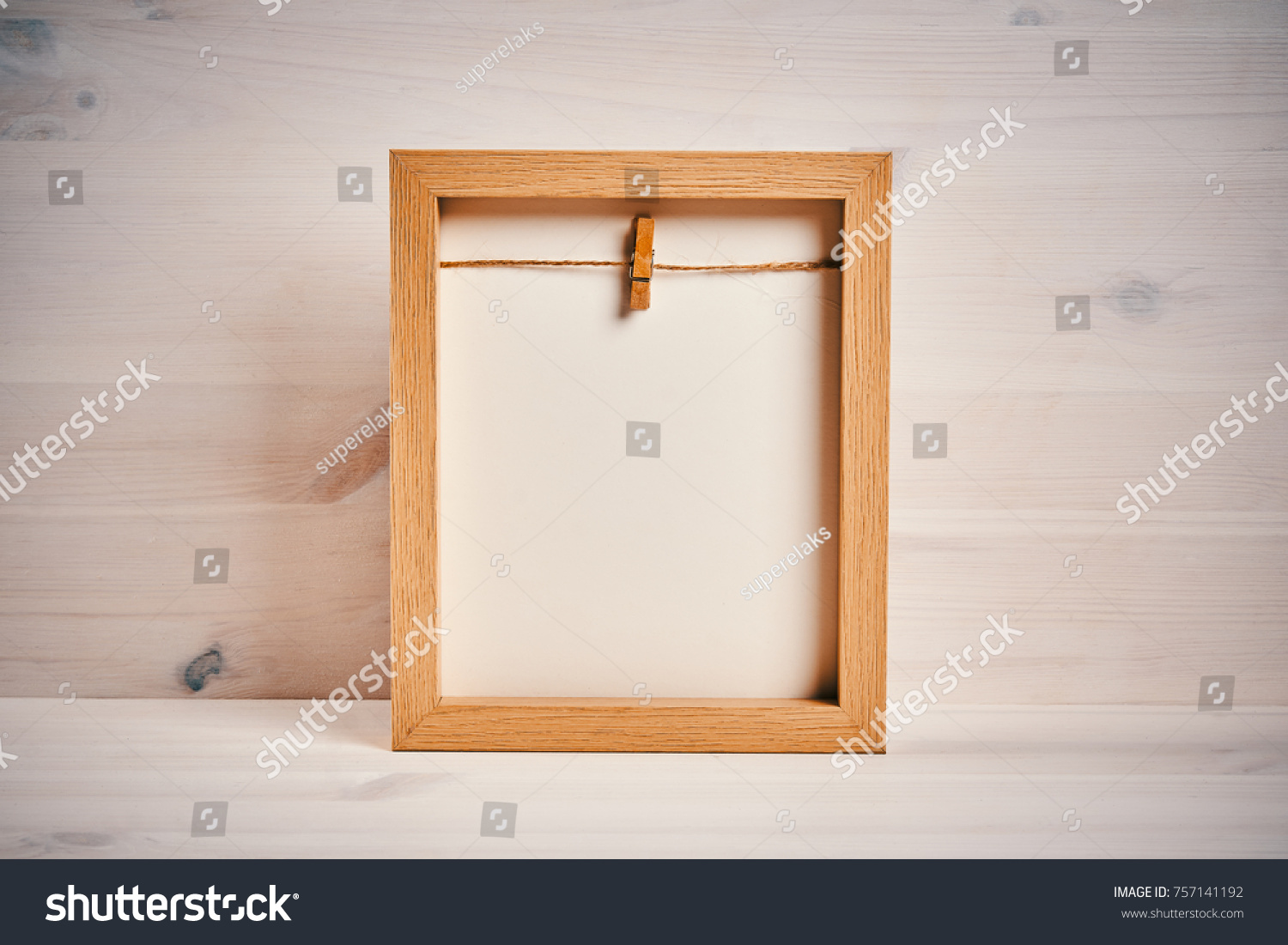 Old empty frame on a shelf on a wooden background #757141192