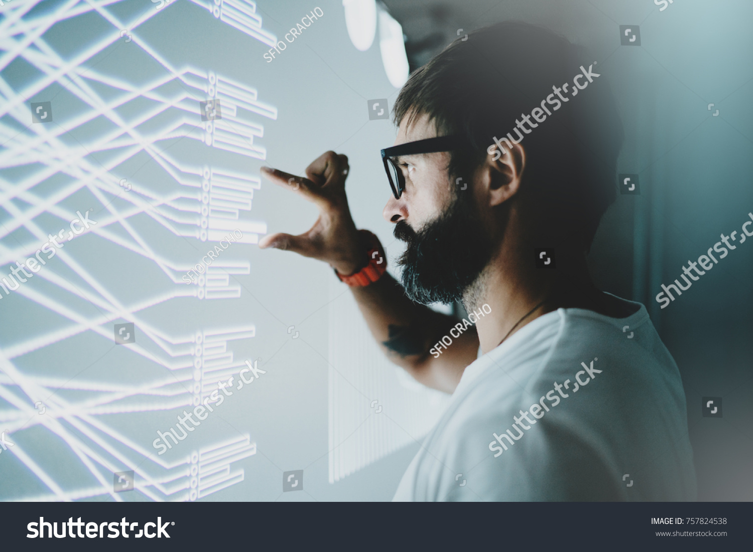 Concept of virtual panel display,diagram,digital graph interfaces.Attractive coworker touching virtual panel with graphs.Blurred background. Horizontal #757824538
