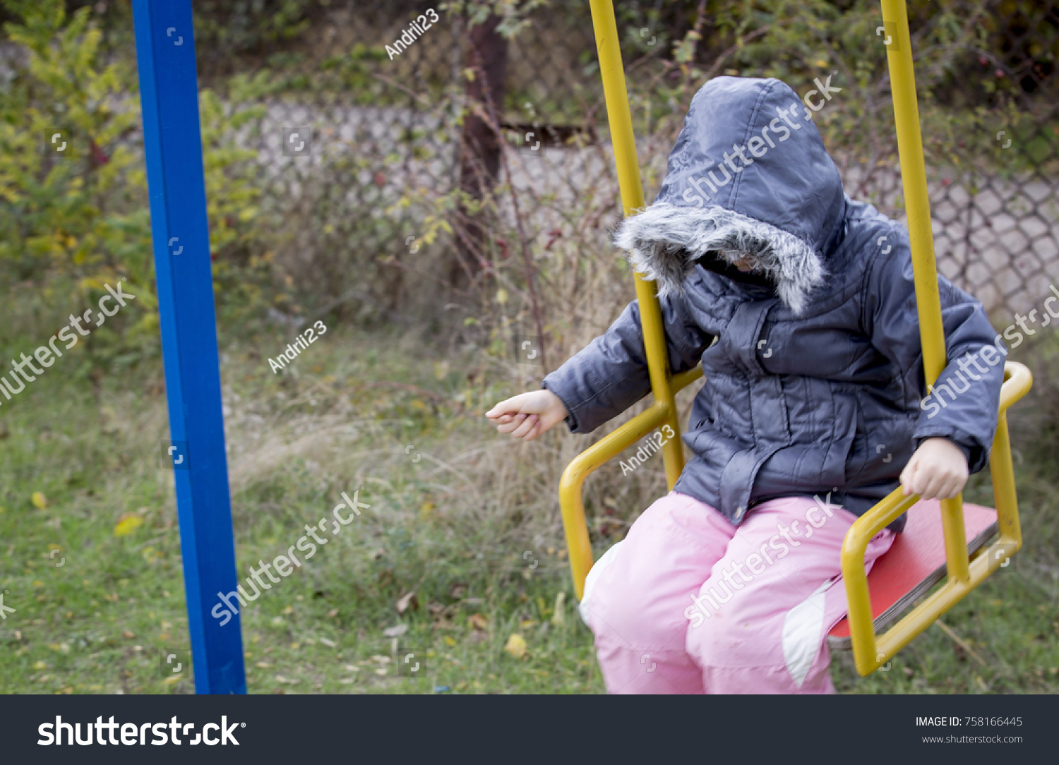 little girl on a swing one sad #758166445
