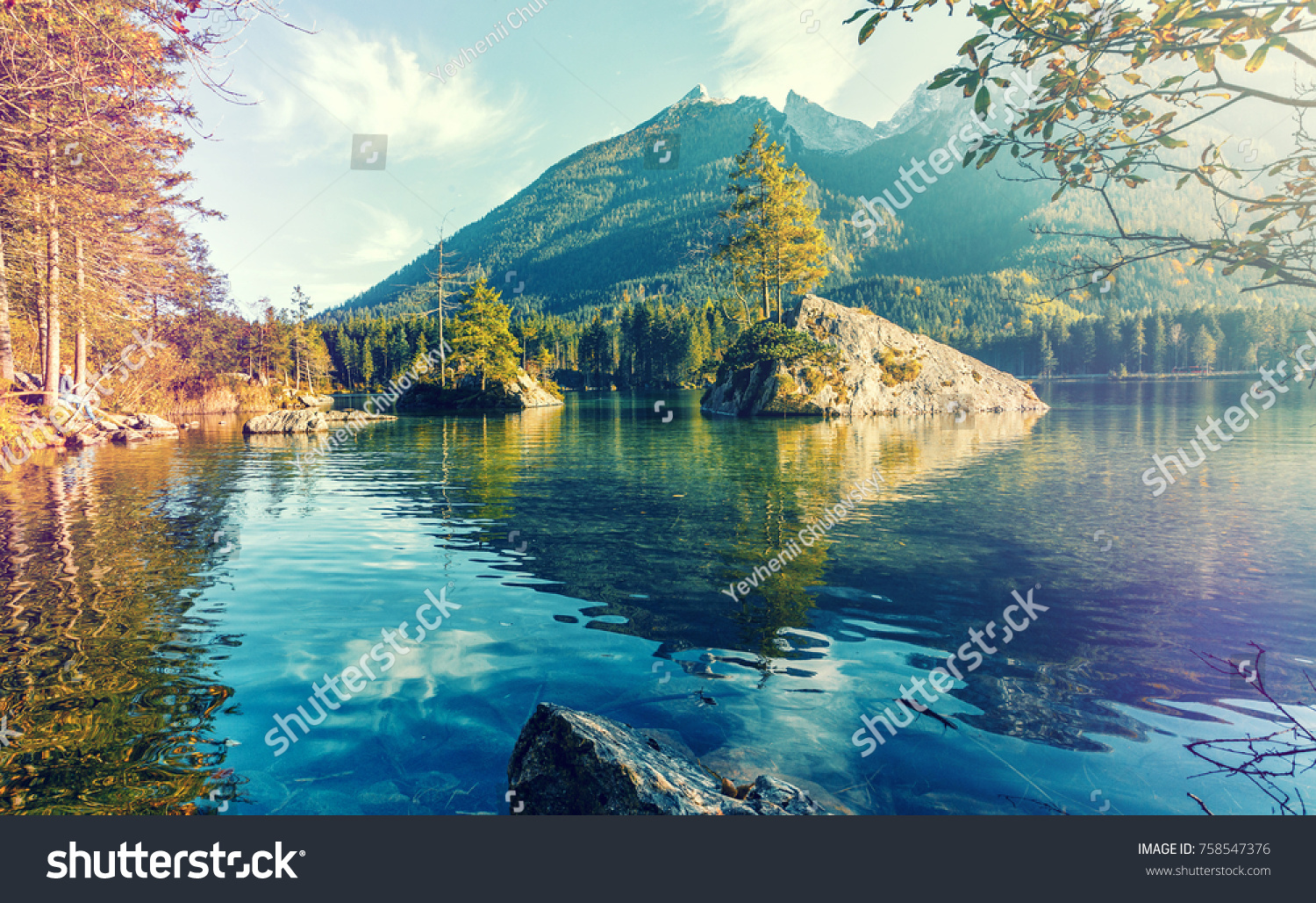 Wonderful nature scene, pine trees on a rock island at sunset, glowing in sunlight, The  Lake Hintersee. Nationalpark Berchtesgadener Land, Upper Bavaria, Germany.  retro style, instagram filter,  #758547376