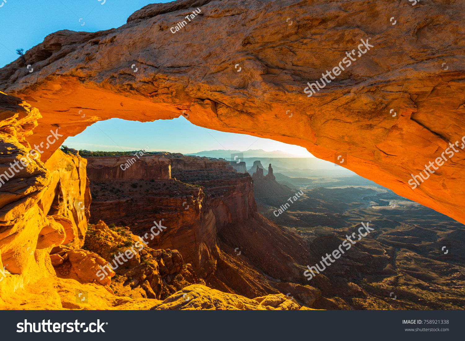 Beautiful Canyonlands view, from Mesa Arch, under warm surise light, on a clear autumn day #758921338