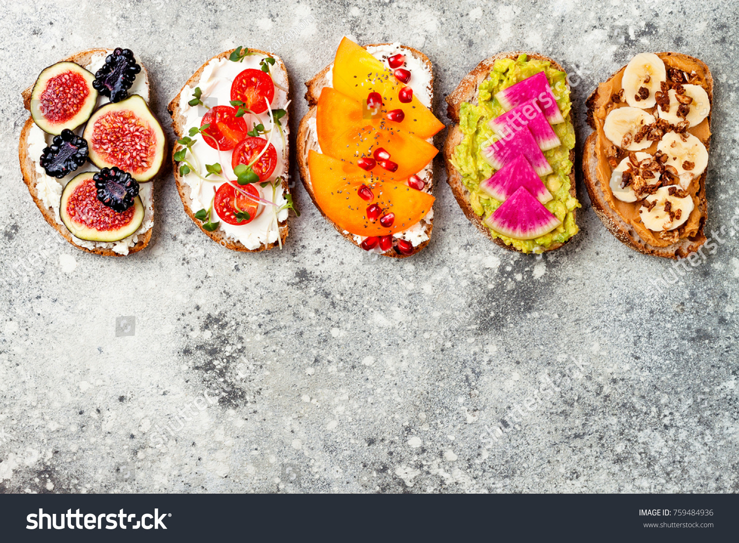 Healthy breakfast toasts with peanut butter, banana, chocolate granola, avocado, watermelon radish, persimmon, pomegranate, chia seeds, tomato, figs, blackberry. Copy space #759484936
