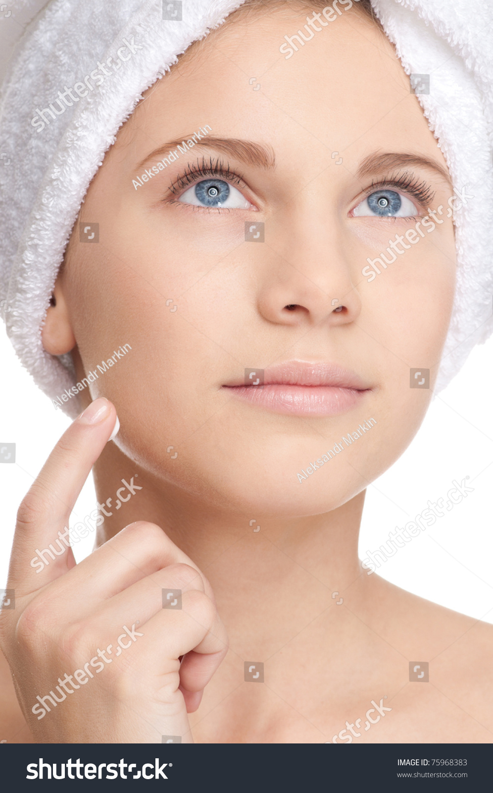Closeup of young beautiful woman with perfect skin applying cream. Spa #75968383