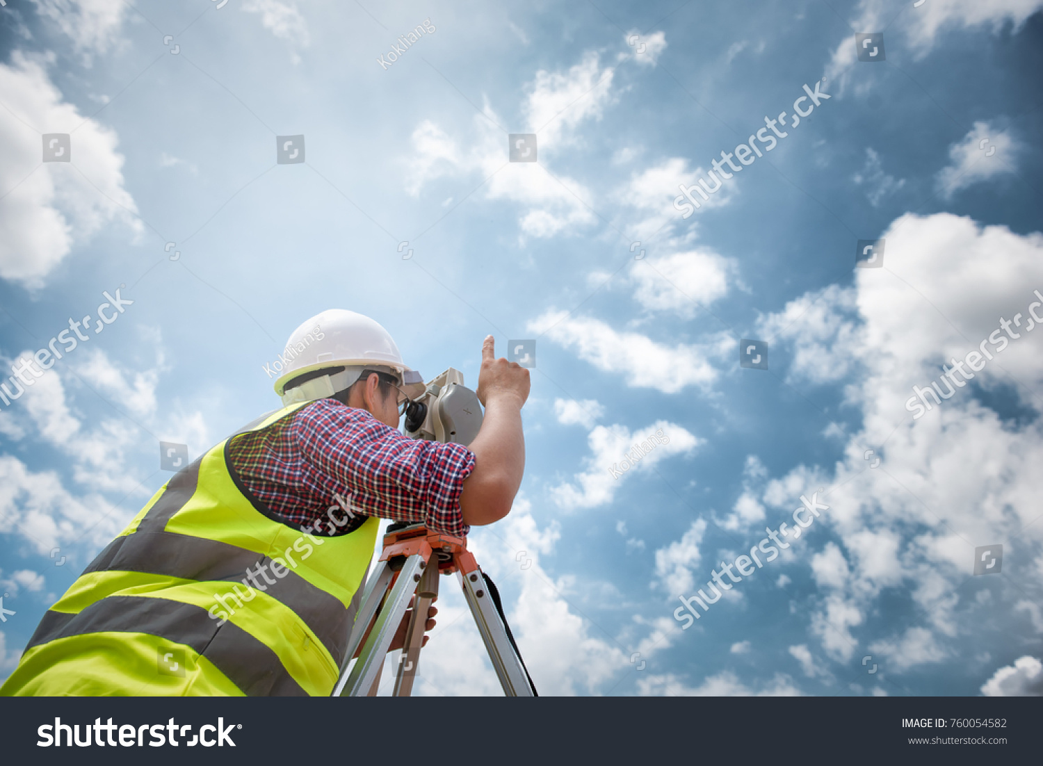 Surveyor equipment. Surveyor’s telescope at construction site or Surveying for making contour plans are a graphical representation of the lay of the land before startup construction work  #760054582