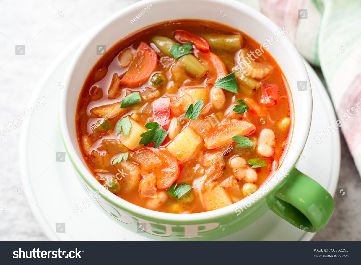 Italian minestrone soup in bowl on gray stone background. Selective focus. #760562293