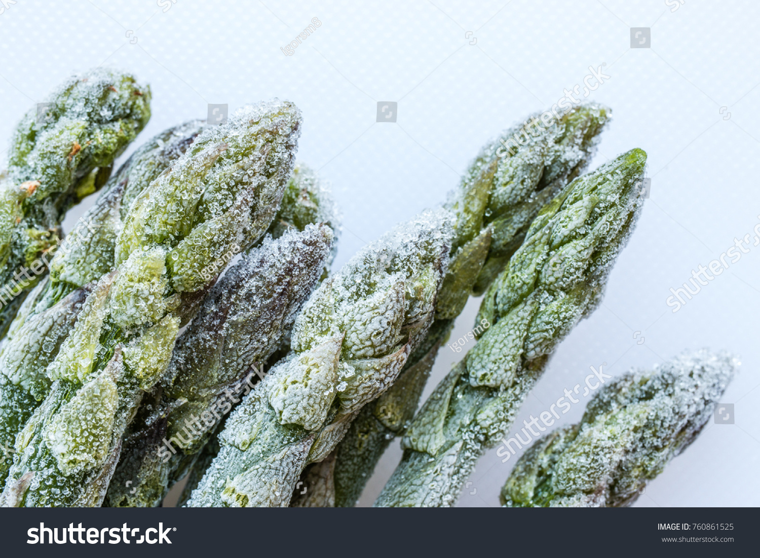 frozen asparagus on white cutting board, top view, macro #760861525