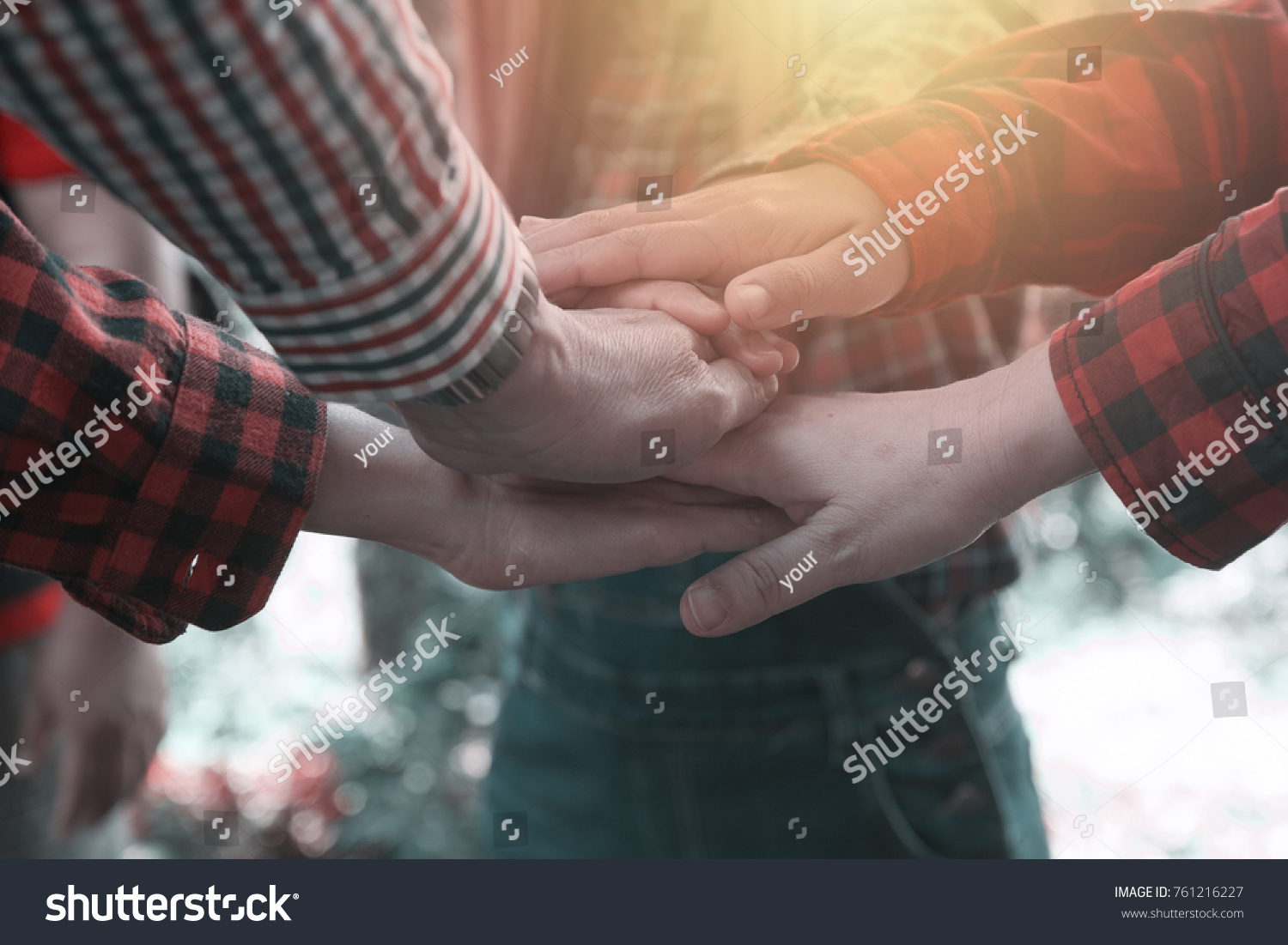 Group of farmer holding together as different  people putting their hands connected linked together and community trust and faith metaphor showing unity.Teamwork concept. #761216227