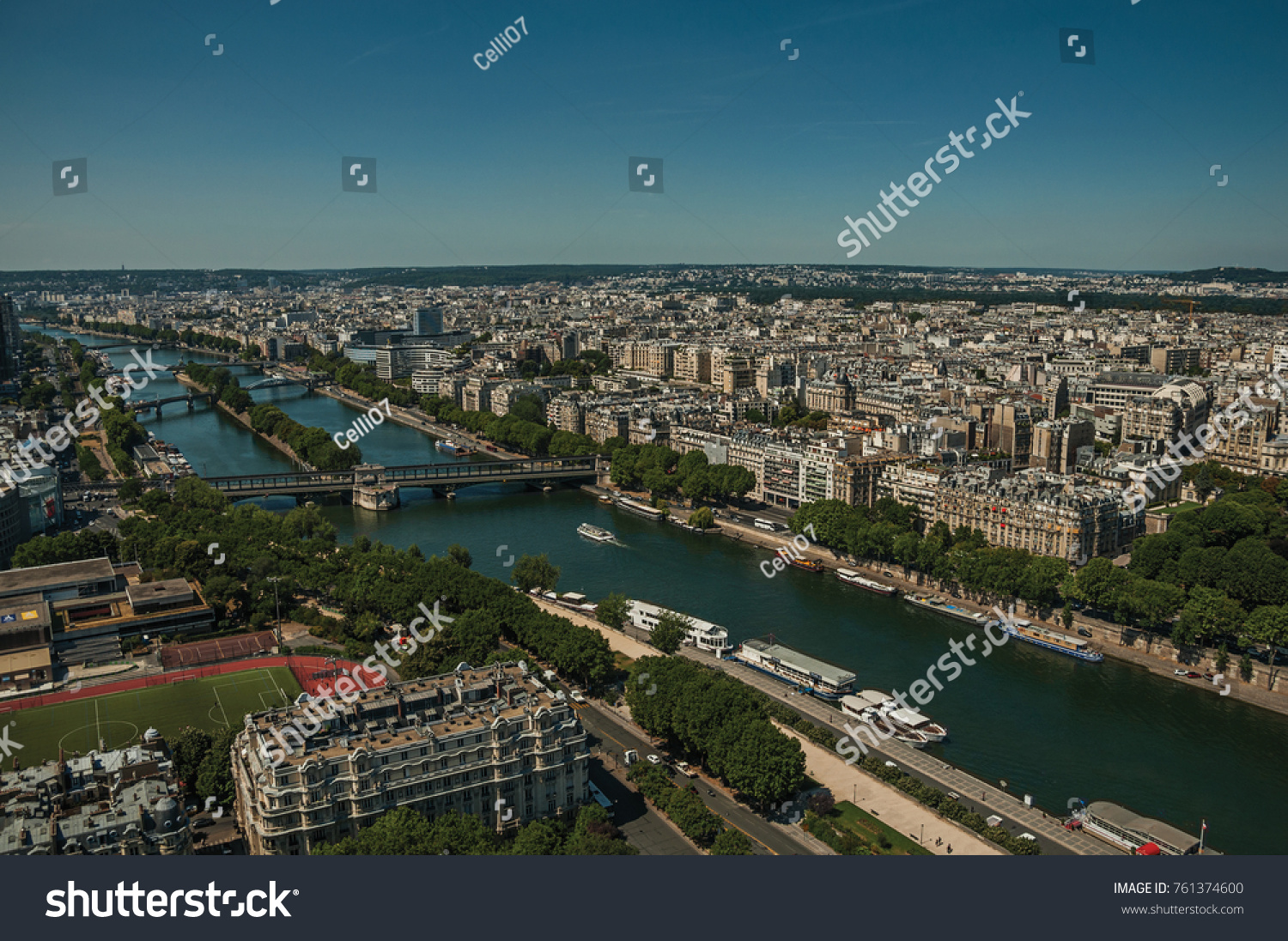 Skyline, River Seine, greenery and buildings under blue sky, seen from the Eiffel Tower in Paris. Known as the “City of Light”, is one of the most impressive world’s cultural center. Northern France. #761374600