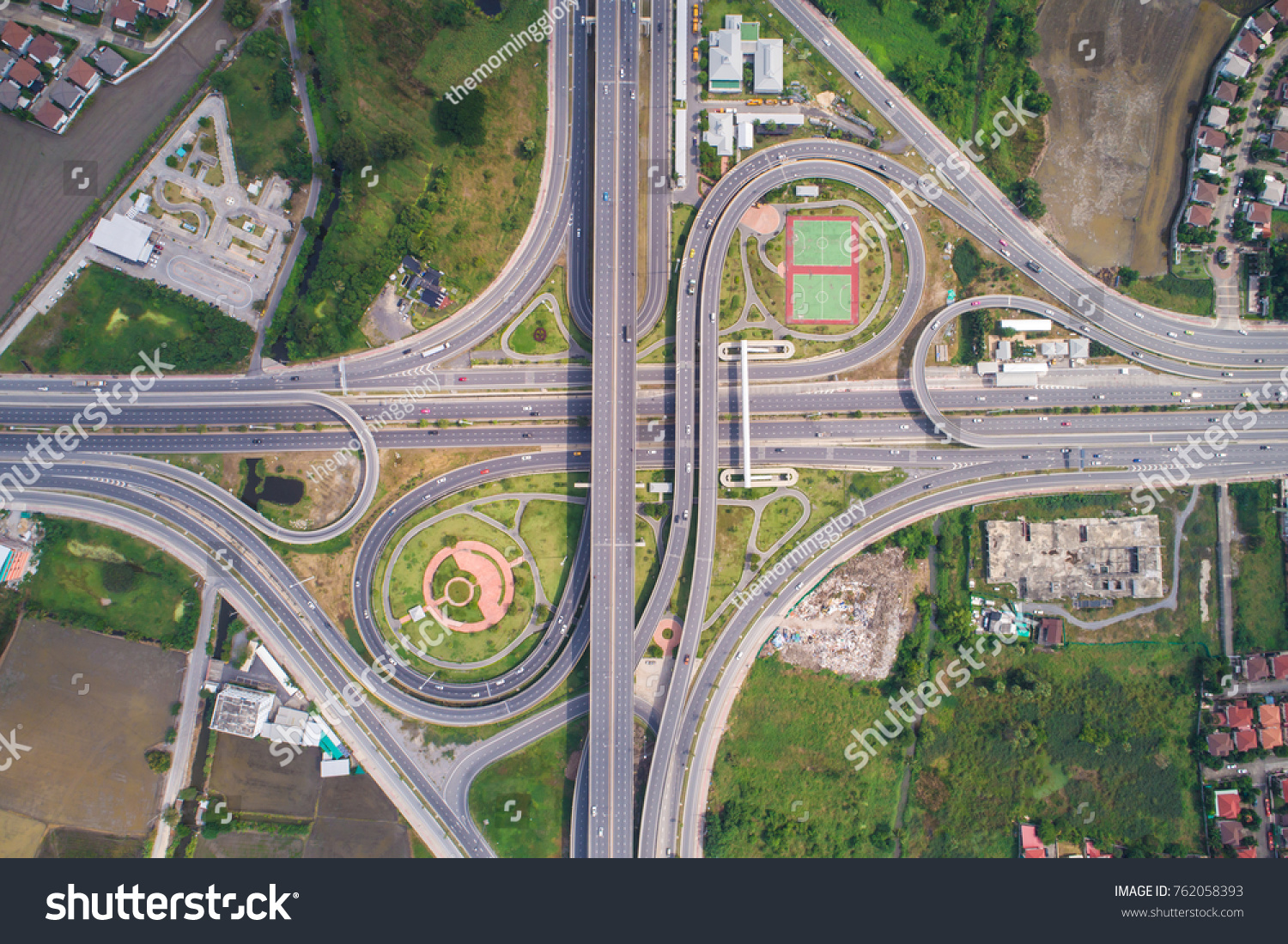 Intersection traffic circle road with car and green tree look down view #762058393