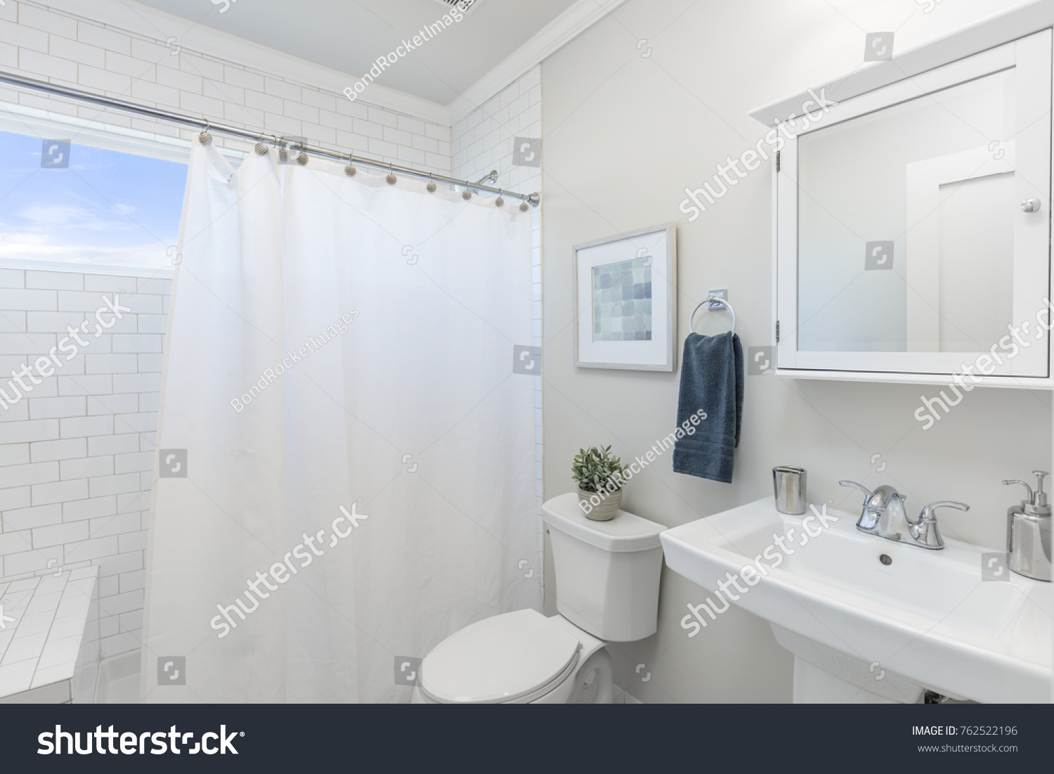 Bathroom with shower curtain.  #762522196