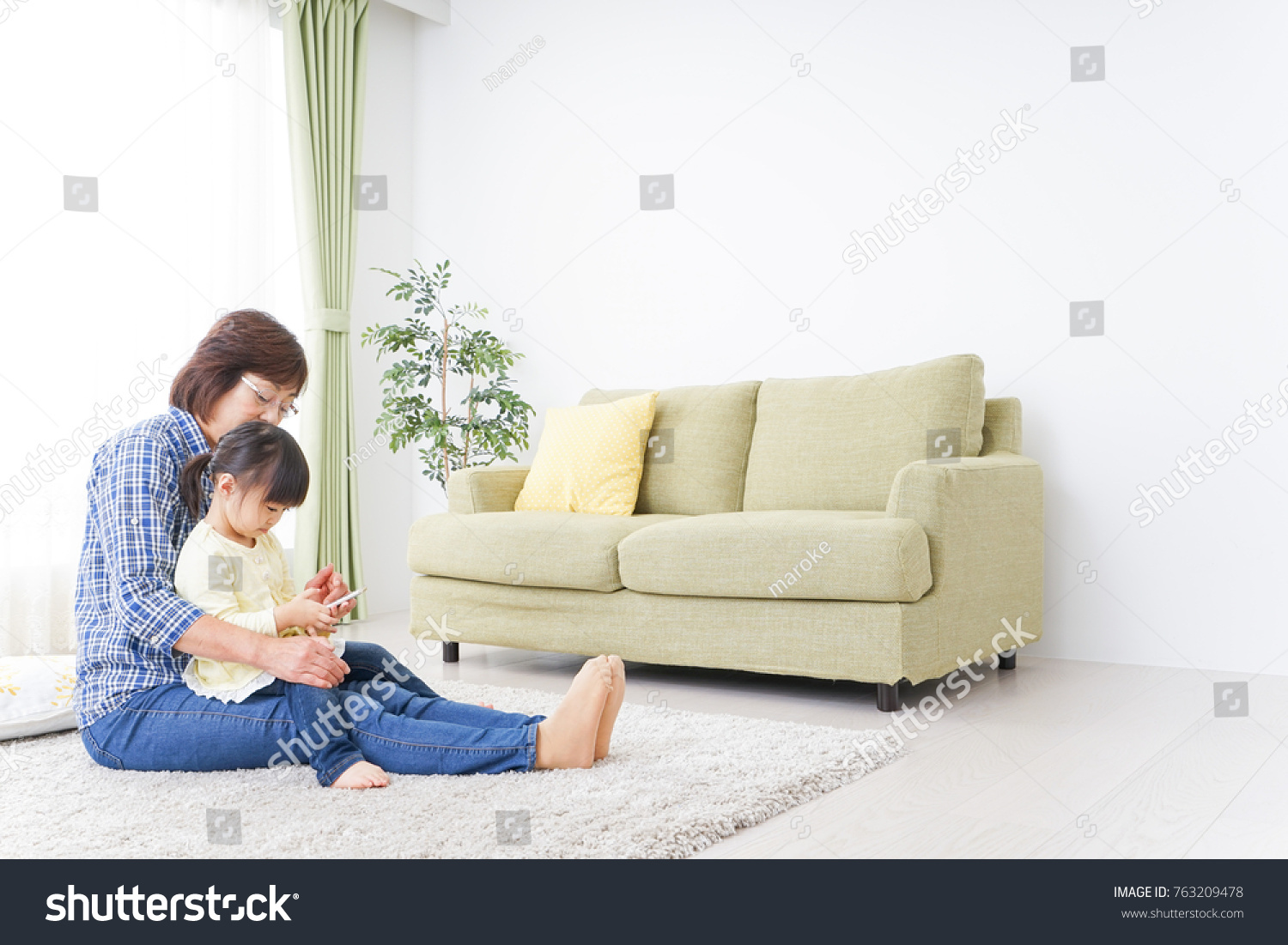 Child using smartphone with grandmother #763209478
