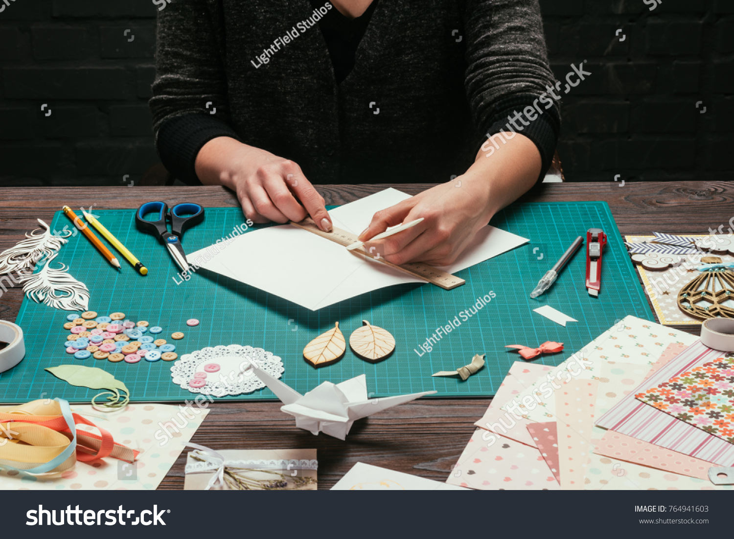 cropped image of designer cutting paper for scrapbooking greeting postcards #764941603
