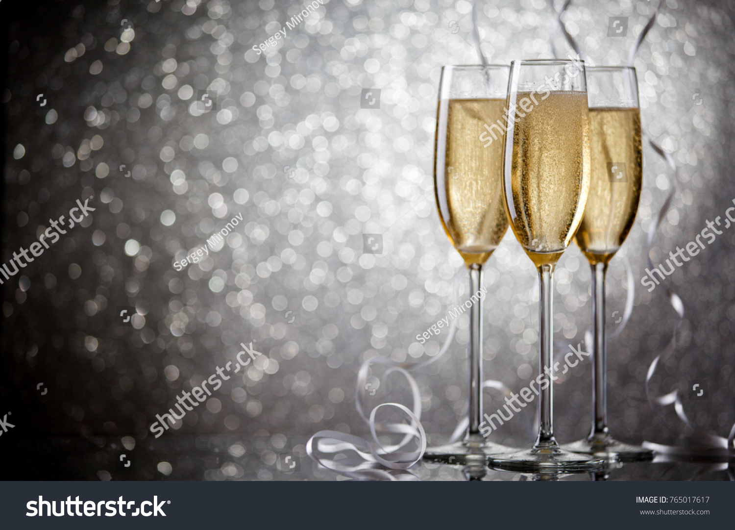 Image of three glasses with wine on gray background #765017617
