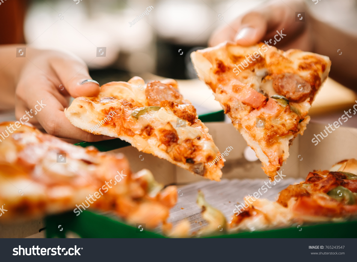 Asian students eating eating the pizza together in breaking time early next study class having fun and enjoy party, Italian food slice with cheese delicious at university outdoor. #765243547