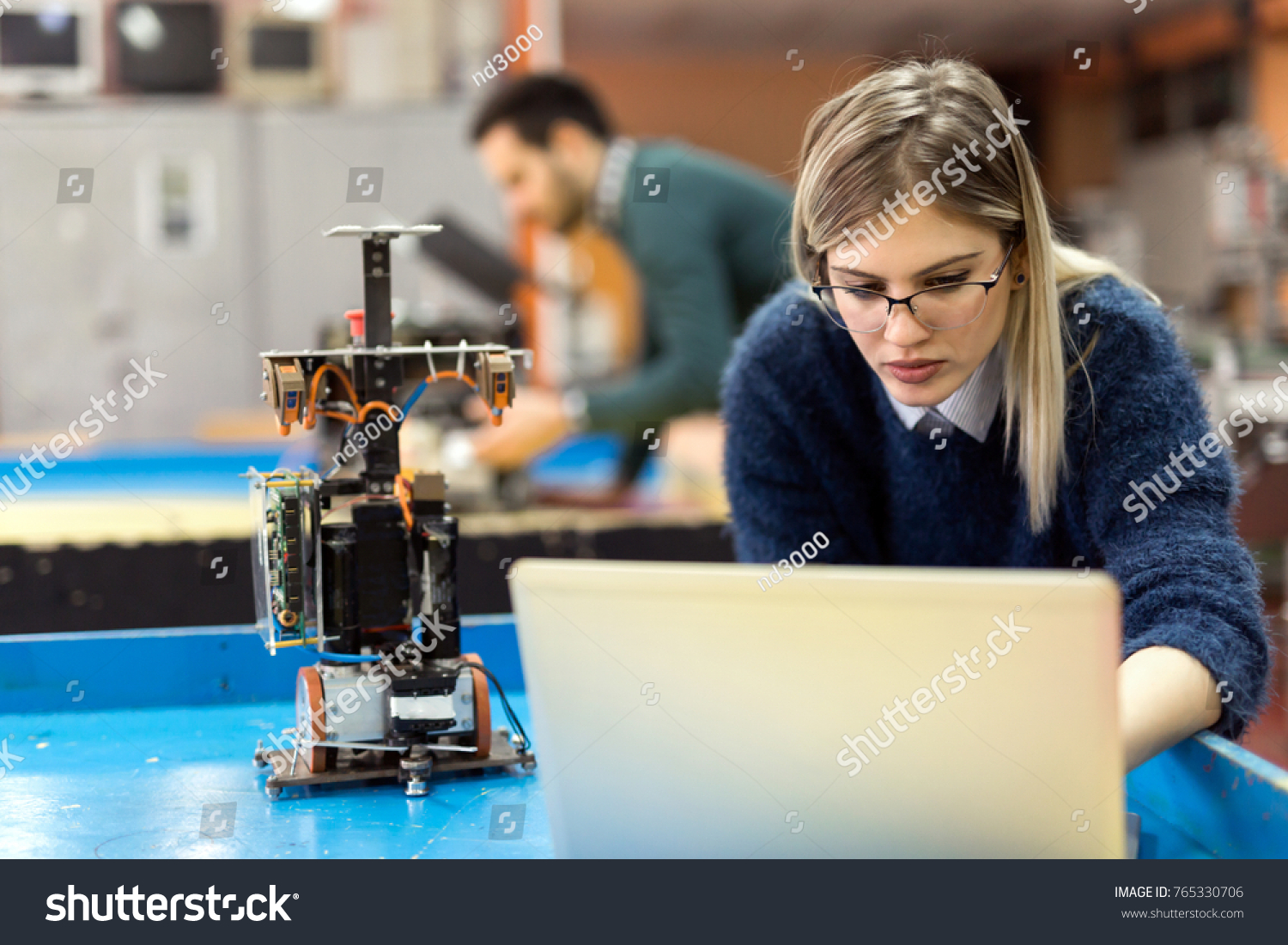 Young woman engineer working on robotics project #765330706