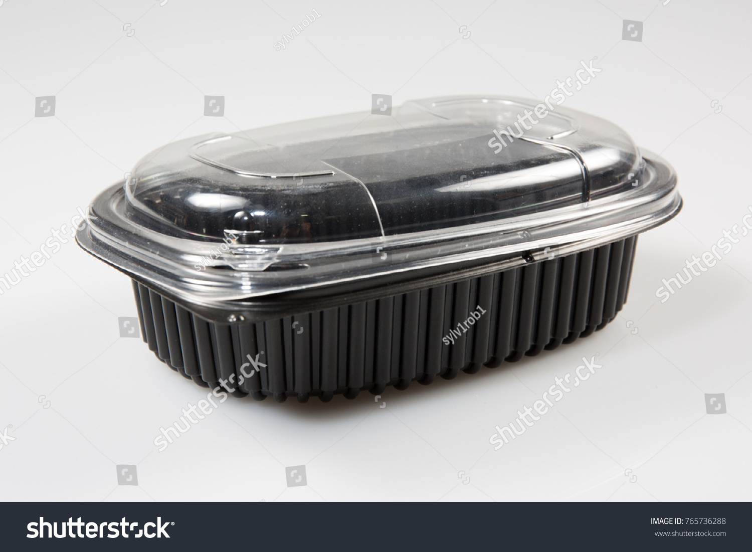 A black and transparent plastic box to put already prepared food #765736288